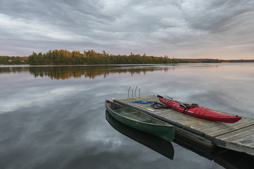 Canoe and Kayak moored at a dock in a lake, Lake of The Woods, Ontario, Canada