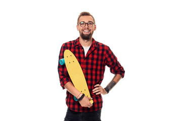 Hipster man over white background holding yellow skateboard. Active guy in plaid shirt with copy space