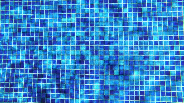 Abstract background. Underwater shoot of blue tile in swimming pool with shiny sunlight reflection.