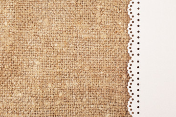 Lace frame on natural linen, bright cloth fabric background. Retro vintage style