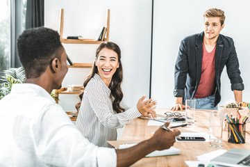 multiethinc business coworkers having conversation during conference in office