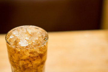 Cold drink with ice on table at restaurant.