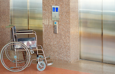 Wheelchair and elevator for disabled, wheelchair waiting in front of elevator in hospital © Choo