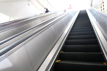 escalator going up in modern office building.