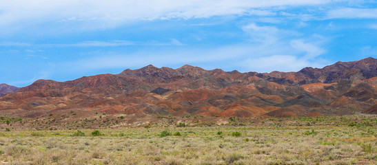 colorful colored mountains in summer, blue sky with clouds, Kazakhstan, Altyn-Emel mountains
