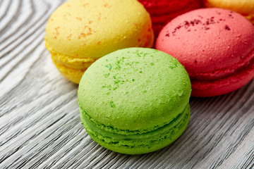 colorful macarons over   wood table. top view