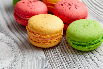 colorful macarons over   wood table. top view