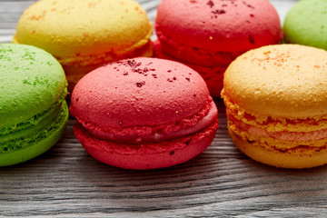 colorful macarons over   wood table. top view