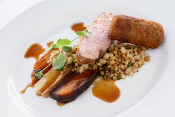 gourmet duck breast plated meal with grain