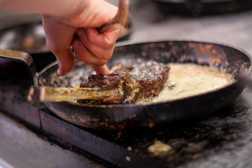 cooking fresh steak in kitchen