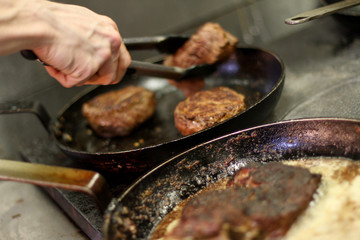 cooking fresh steak in kitchen