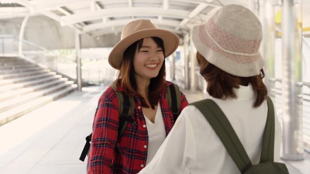Traveler backpacker Asian women lesbian lgbt couple travel in Bangkok, Thailand. Happy young female spending holiday trip at amazing landmark and enjoy her journey in traditional city.
