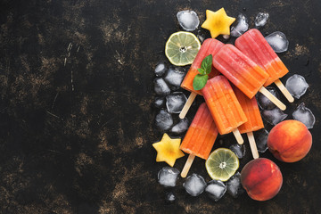 Peach fruit ice cream with ice and mint leaves on a dark background. Top view. Copy space,flat lay.