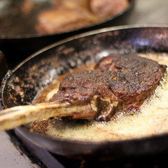 cooking fresh steak in kitchen