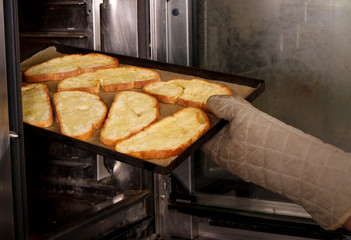 chef preparing toasted bread with olive oil