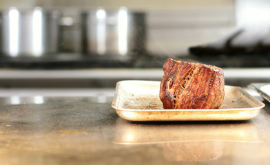 cooking fresh steak in kitchen