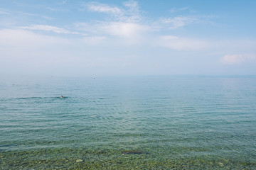 Minimal seascape with a person swimming