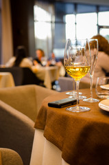 Glasses with white wine on blurred background