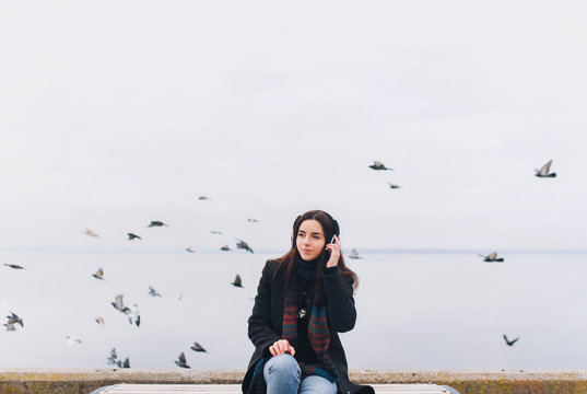 Beautiful Girl Listening To Music On Headphones On A Nature Background. Enjoy Your Favorite Song. Copy Space.