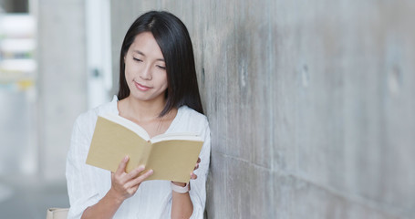 Woman read on book in university campus