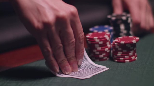 Woman playing poker and checking cards