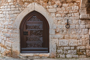 Fototapeta na wymiar Ornate old door in the picturesque medieval city of Eze Village in the South of France along the Mediterranean Sea