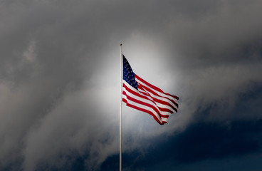 The American Flag flies high in front of an approaching storm