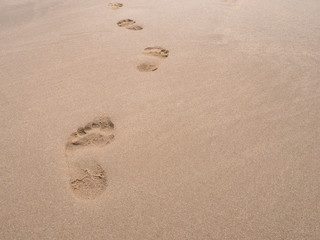 close up footprint on sand at the beach background