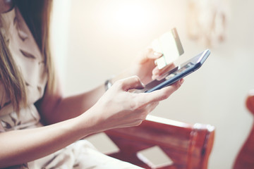 woman asian using phone and credit card shopping online , selective focus on hand