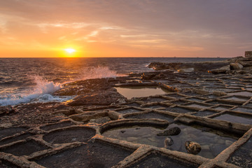 The sunrise over the salt pans, or salters, in Malta (Mediterranean sea)