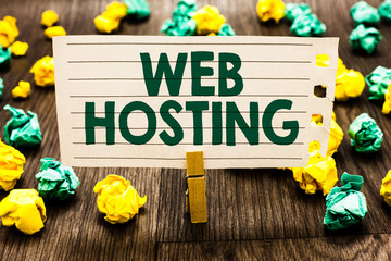 Text sign showing Web Hosting. Conceptual photo The activity of providing storage space and access for websites Clothespin holding notebook paper crumpled papers several tries mistakes