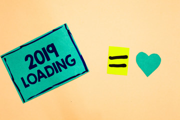 Text sign showing 2019 Loading. Conceptual photo Advertising the upcoming year Forecasting the future event Turquoise piece paper reminder equal sign heart sending romantic feelings