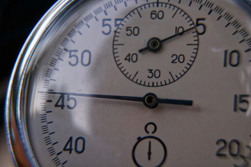 Stopwatch lies on bench close-up, time shift concept