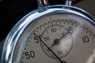 Stopwatch lies on bench close-up, time shift concept