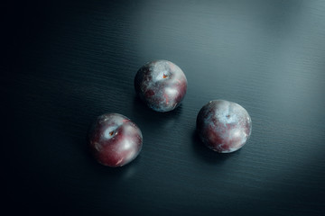 Plums on the dark table