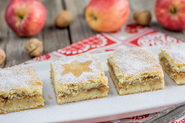 Buttered cut dessert from apple with walnuts