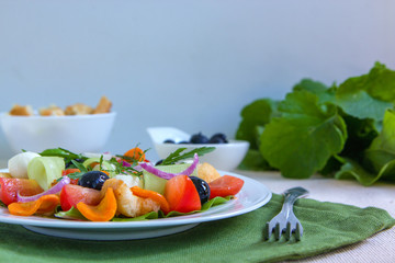 Dietary salad of cucumbers, tomatoes and carrots.