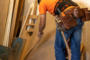 Man with tool belt in a workshop