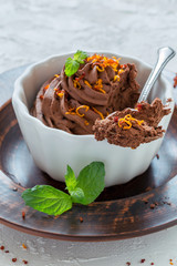 Chocolate mousse in a bowl and a dessert spoon.