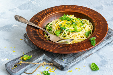 Pasta with cream sauce, zucchini and lemon zest.
