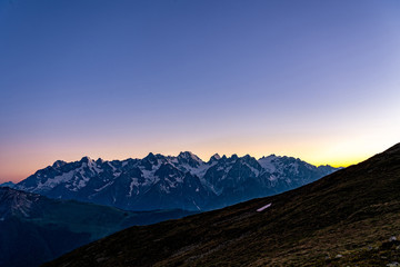 Naklejka na ściany i meble Scenic view of beautiful Swiss Alps mountains. Blue hour sunset with pink and blue tones, Verbier, Canton du Valais, Wallis, Switzerland.