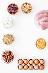 Healthy food. Products rich protein and fiber. Legumes, nuts, low-fat cheese, meet, eggs. Raw beans, chickpeas, lentil, almond, hazelnut on white background top view copy space