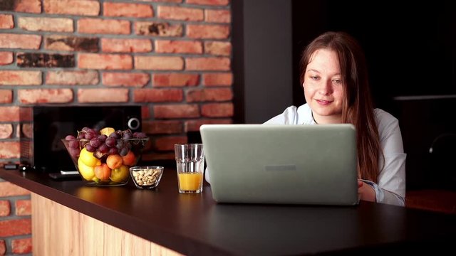 Young pretty woman working on laptop at home
