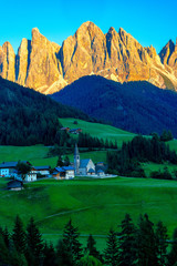 Vertical image of Santa Maddalena church with odle group behind