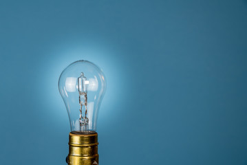 Halogen lightbulb against a blue background
