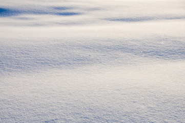 Snowy background, winter, shadows on the snow