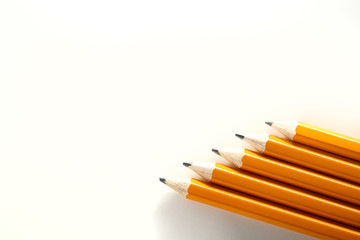Obraz premium Yellow orange school homework pencils on white background