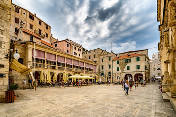 Fototapeta na wymiar old square with clouds and ancient buildings