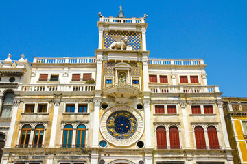 View on the St Marks Clocktower in San Marco Square in Venice, Italy on a sunny day.