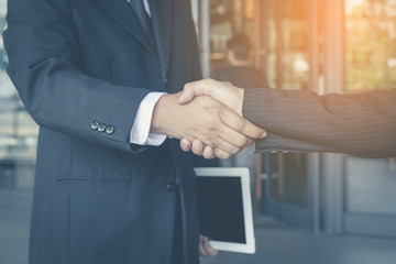 Close up view of business partnership handshake concept.
